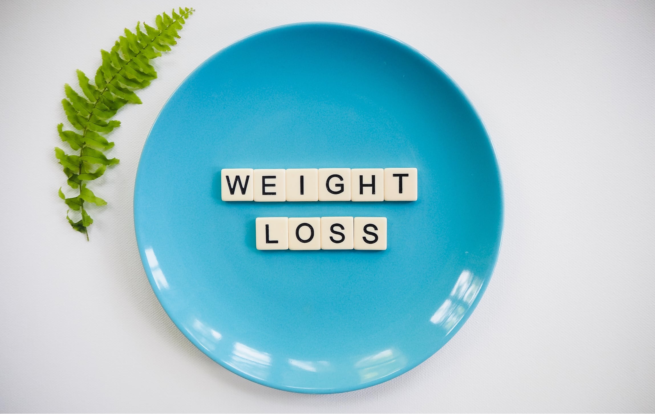 Scrabble letters on a plate, spelling weight loss