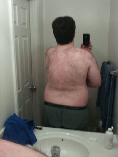 A progress pic of a person at 303 lbs