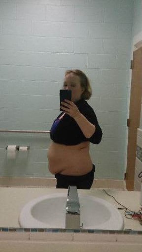 A picture of a 5'4" female showing a weight cut from 220 pounds to 163 pounds. A net loss of 57 pounds.